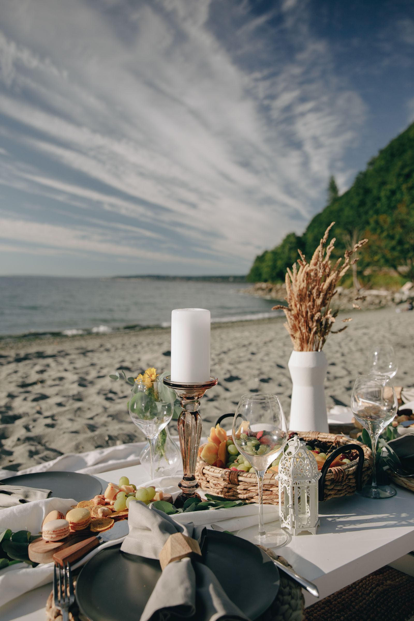 Dinner table set on the beach at sunset for a vacation chef experience